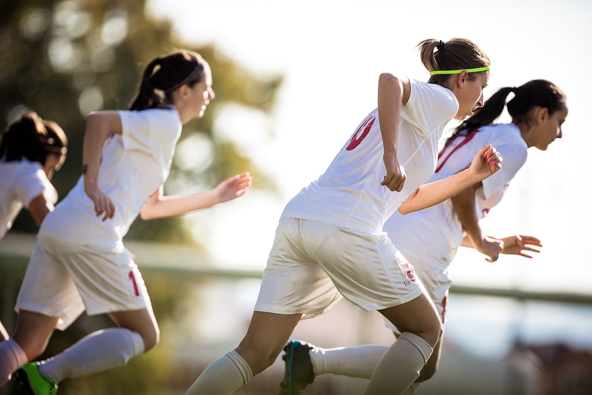 Women's football team running