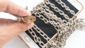 Mobile phone with chains wrapped around it and locked
