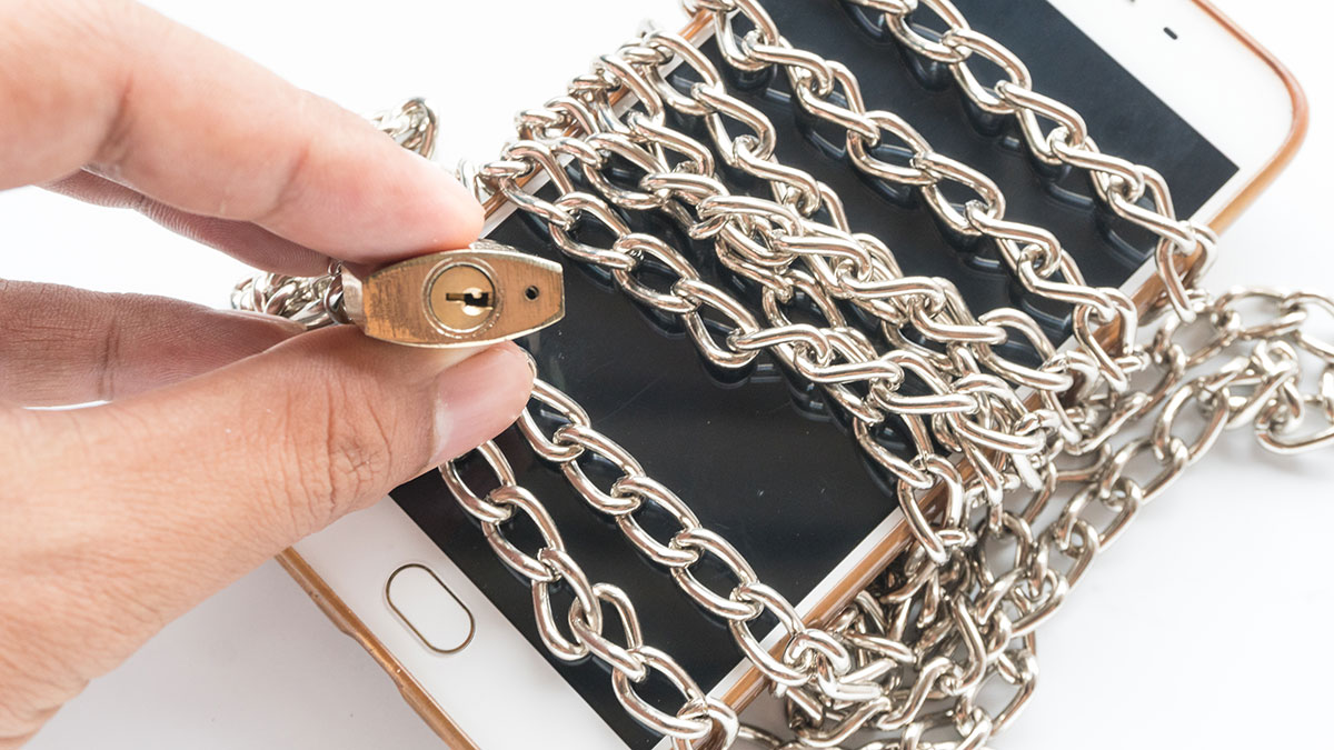 Mobile phone with chains wrapped around it and locked