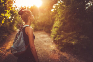 Woman enjoying the sun in the woods