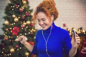Woman listening to a Christmas Playlist.