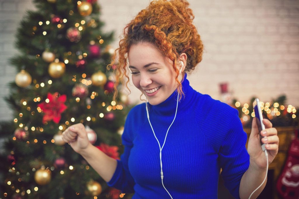 Woman listening to a Christmas Playlist.