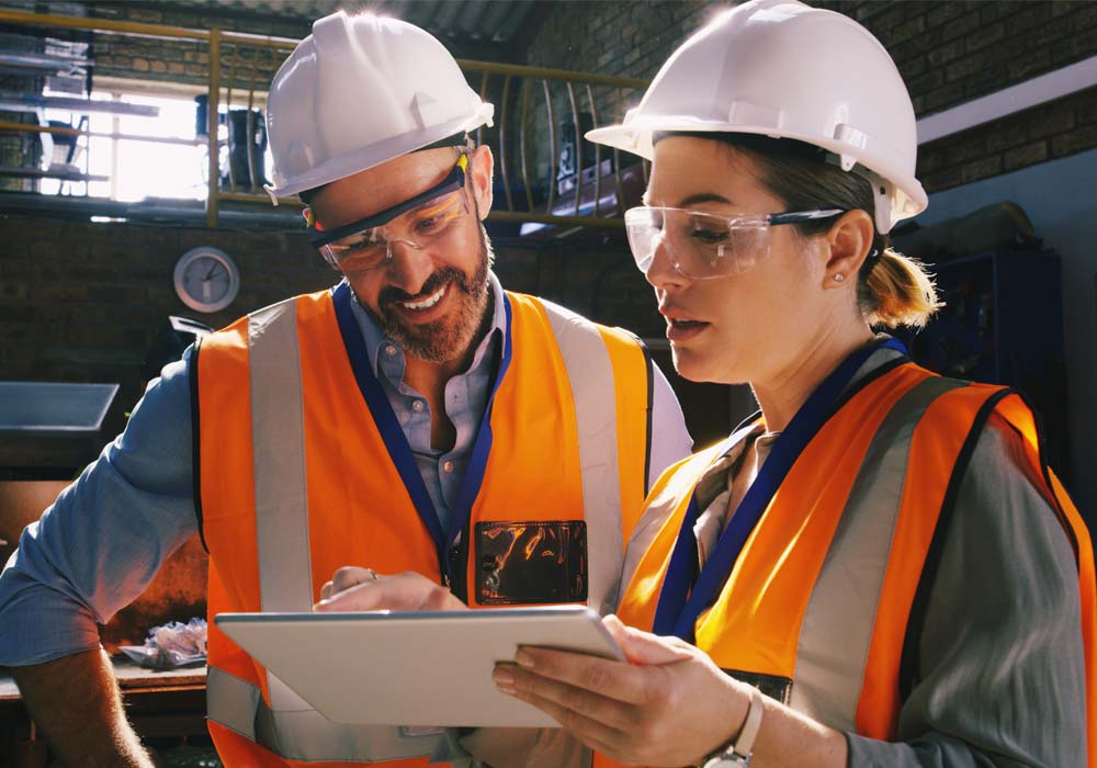 A male and a female construction managers using a digital tablet together