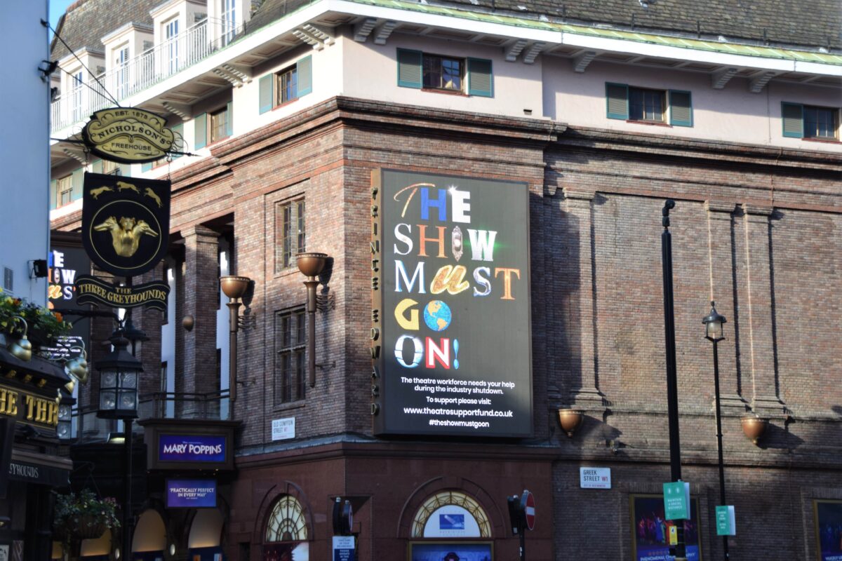Support the arts poster on a theatre.
