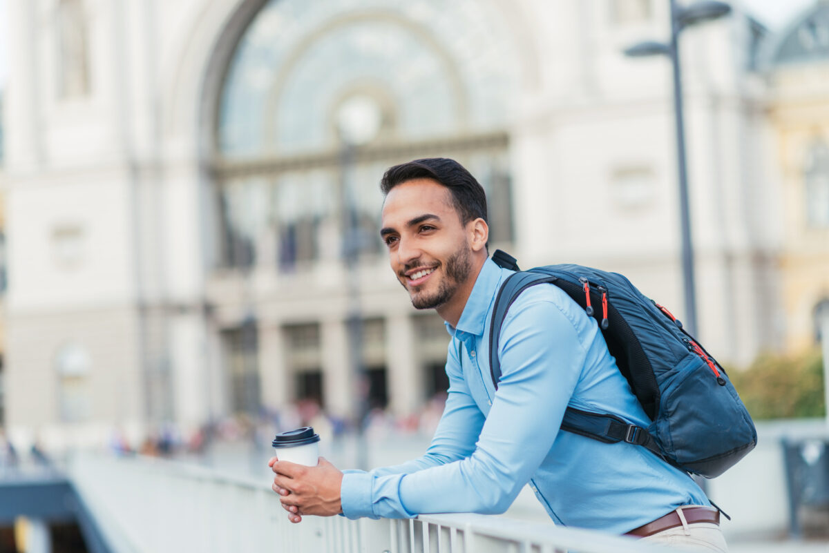 Businessman in smart casual clothing by train station.