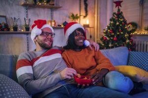 Young couple watching tv at home