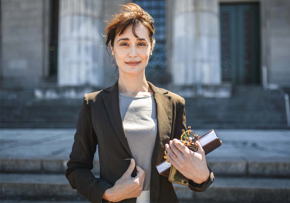 Smartly dressed women stands outside Law Court
