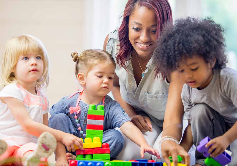 An Early Childhood teacher is working with a group of young children