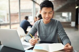 22 motivational quotes for students - man sitting in front of laptop
