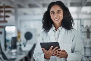 Female health worker smiling at camera for What can you do with a master's in public health promotion blog